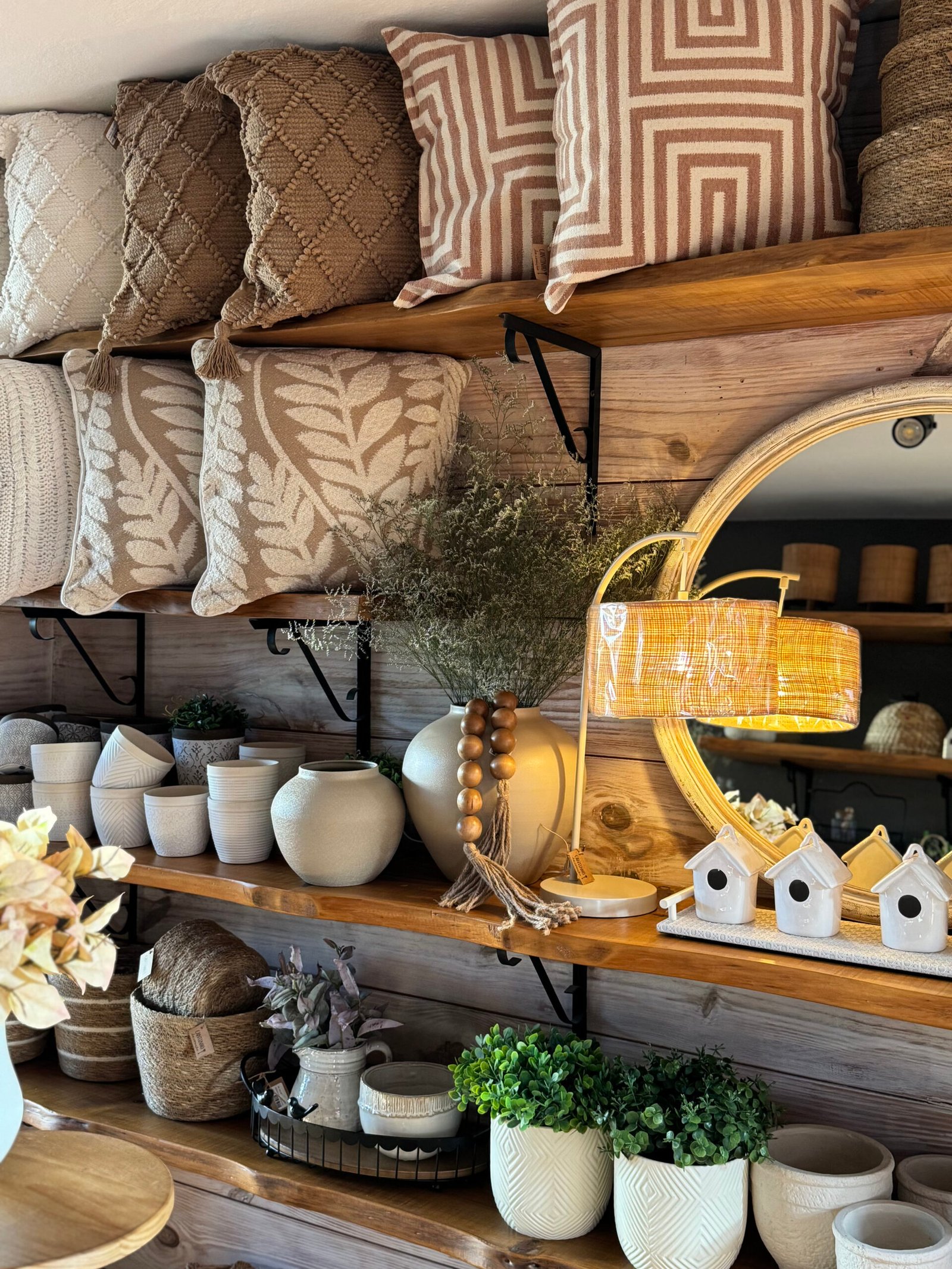 Decoração sofisticada com almofadas, espelho e objetos decorativos